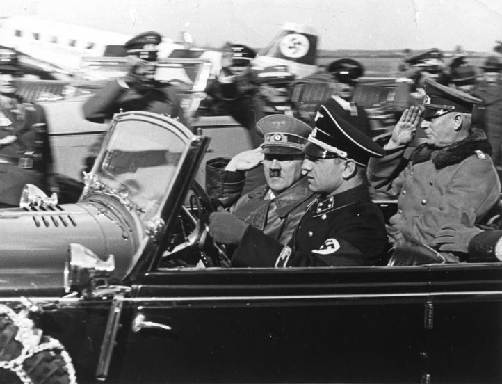 Adolf Hitler and Wilhelm Keitel arrive in an open car at Munich's airport before their flight to Austria